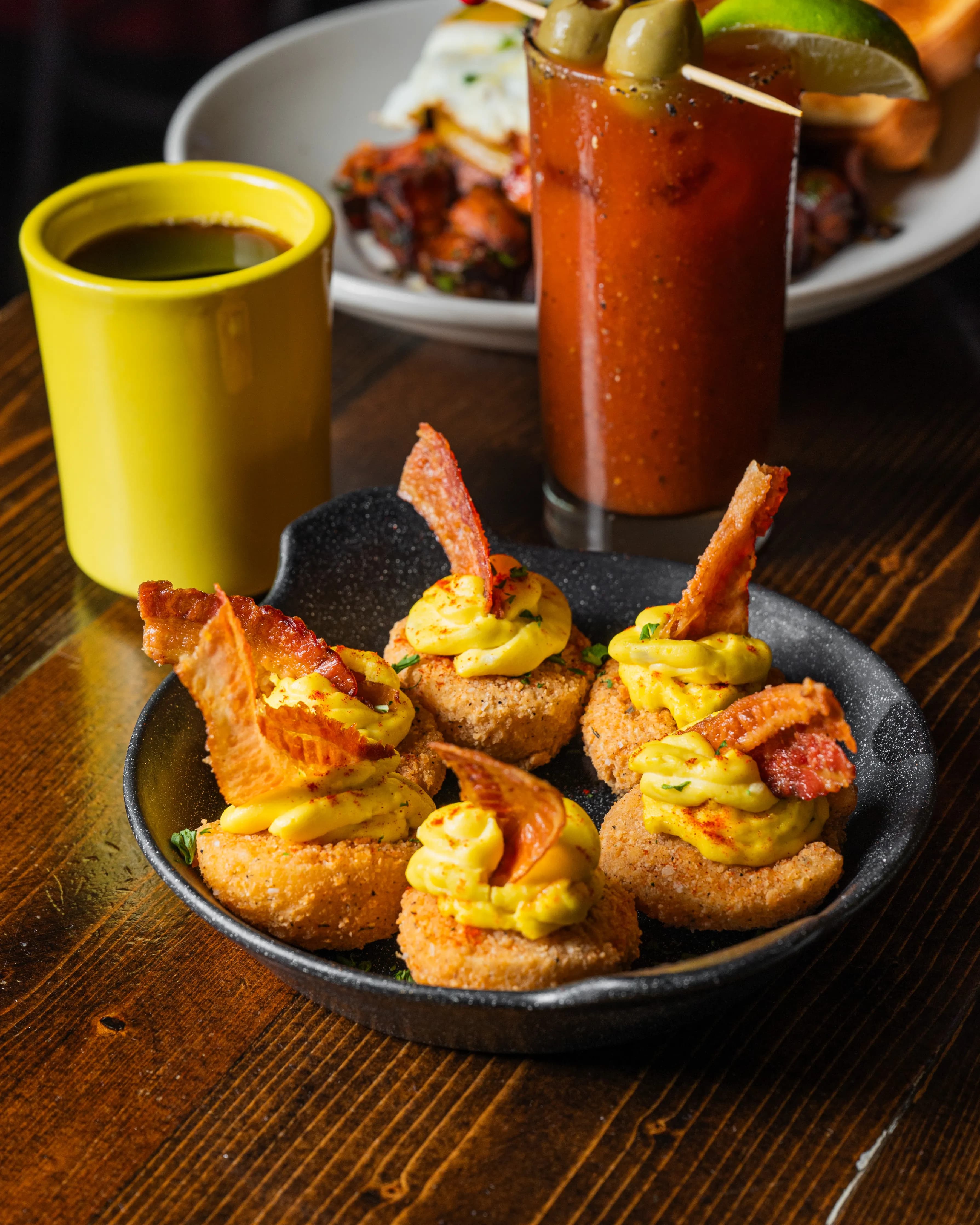 Deep fried deviled eggs Golden fried deviled eggs topped with bacon and mustard