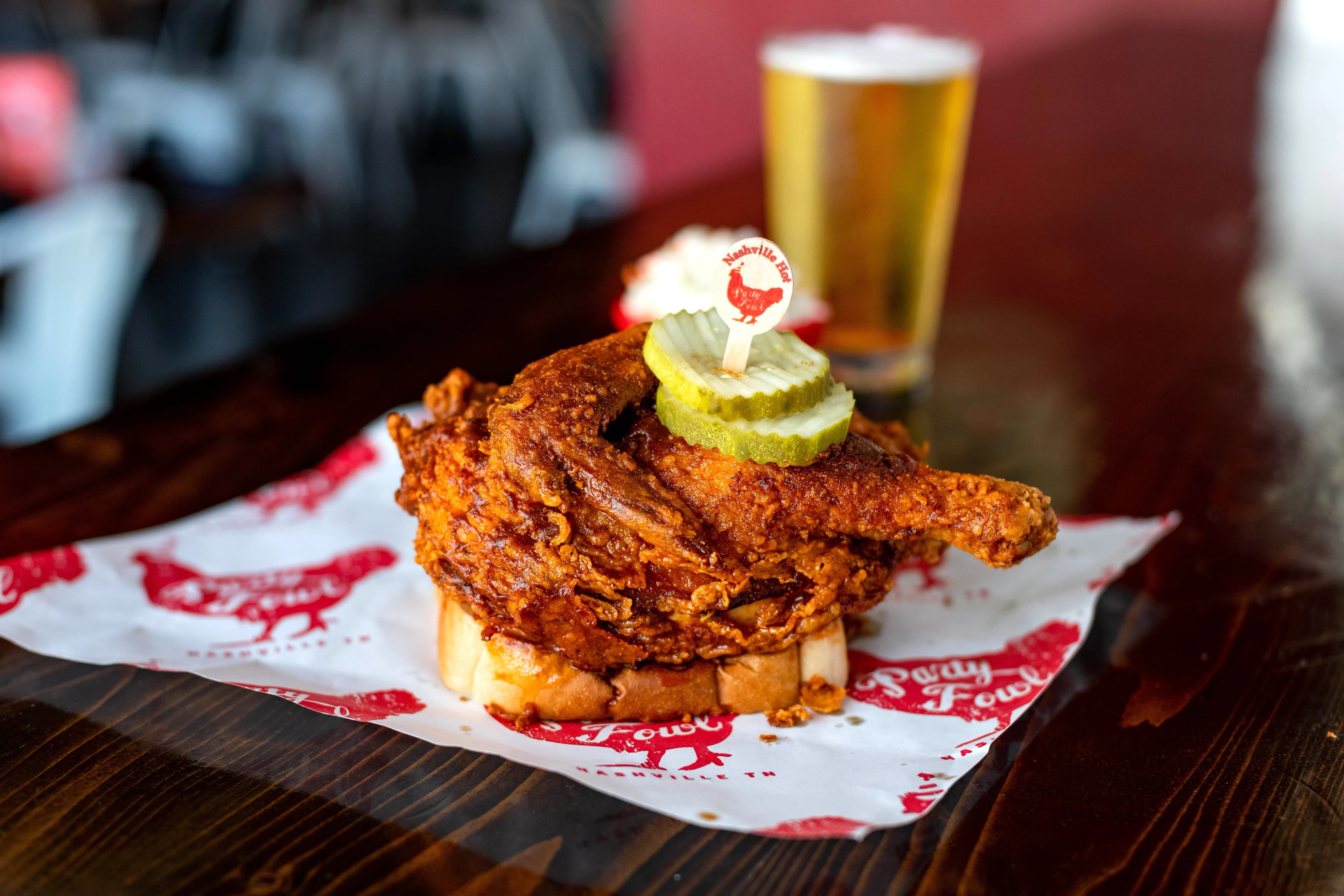 HalfBird2 A crispy fried chicken sandwich topped with pickles and a toothpick