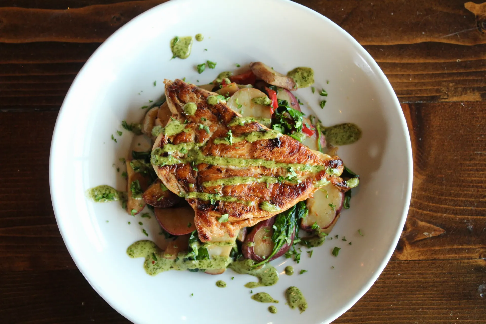 LimeLight Chicken Grilled chicken breast with roasted vegetables and a vibrant green sauce.